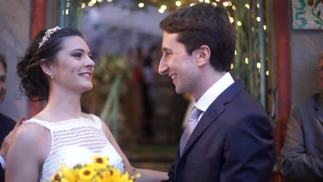 Bride and grrom walking the aisle after wedding cerimony Newlywed couple kissing posing for photos and love ones