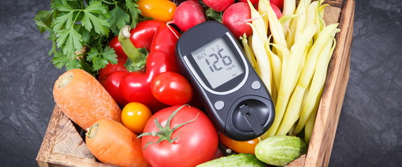 Glucometer with fresh vegetables as source minerals and vitamins. Diabetes, healthy lifestyles and...