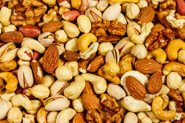 Background of mixed nuts (walnuts, pistachio, almond, peanut, cashew, hazelnut). Healthy eating concept