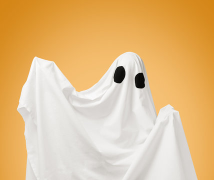 Cute white ghost on Halloween holiday.