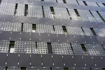 The appearance of new high-rise buildings made of glass and concrete on a blue sky background