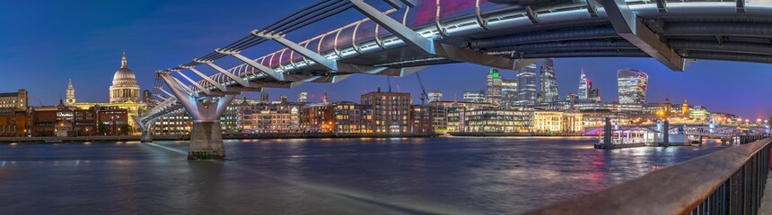 Night panorama of the Thames river with Millennium bridge and Saint Paul's Cathedral and the City...