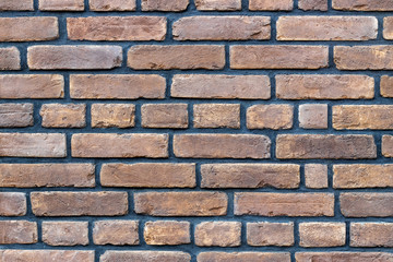 Gray red brown brick wall background, close-up view.