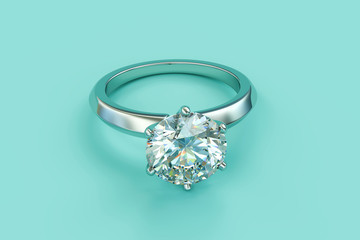 Solitaire diamond engagement ring on turquoise background