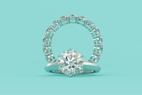 Solitaire round cut diamond engagement ring, eternity ring on turquoise background