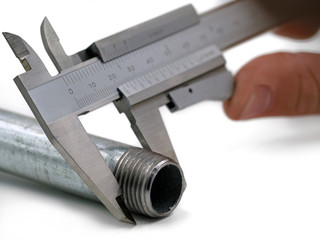 Precise measurement of a thread with a vernier caliper isolated on white background