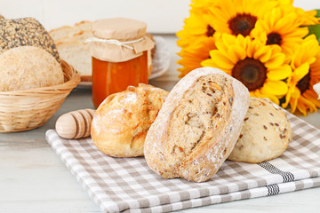 Buns and breads on breakfast table.