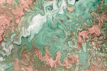Pink gold grains are randomly scattered on Free flowing paint. Marble background or texture in mint and pink colors