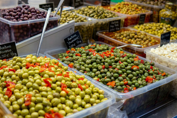 Fototapeta na wymiar spanisch green Olives with pepper and pickled garlic for sale at farmers market in spain Malaga