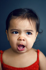 brunette girl in a red t-shirt posing in the Studio