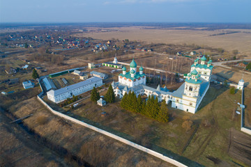 Temples of the Nikolo-Vyazhishchi Monastery on an April sunny evening (aerial photography). Vyazhishchi, Novgorod region. Russia