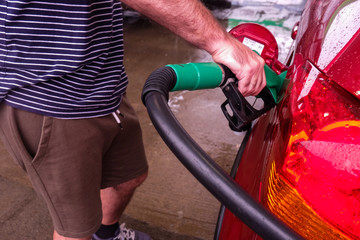 close up of a man filling his car on gas station