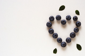 heart shaped blueberries on a white background