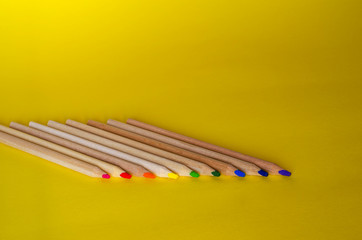 multi colored pencils on a yellow background 3