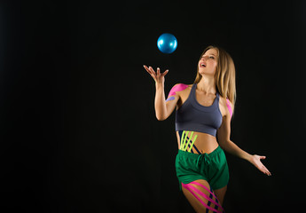 Girl trains with ball, color tapes