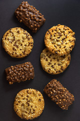 Appetizing sweet dessert with chocolate and oatmeal for morning fragrant coffee on black background