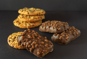 Appetizing sweet dessert with chocolate and oatmeal for morning fragrant coffee on black background