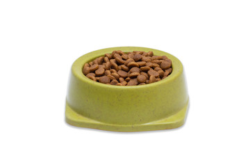 Dry pet food in a green bowl isolated on white background. Front view