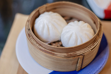 Fototapeta na wymiar Salapao or pork steamed bun served in the basket. Ready to eat. Traditional Chinese food