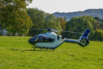 Helicopter landed in the middle of a field