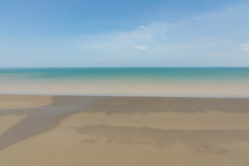 aerial view of the sea and mudflat coastline at low tide