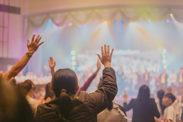 Soft focus of Christian worship with raised hand,m