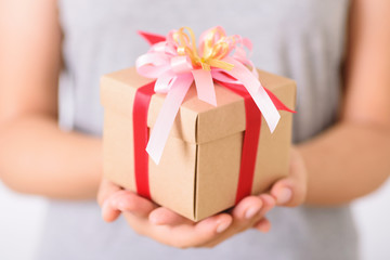 Woman hands holding gift box for giving in special day