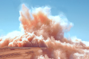 Dust clouds after the detonator blast in the desert 