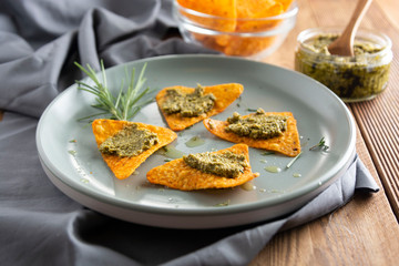 Nachos chips or corn mexican chips with guacamole, pesto pasta healthy food snack