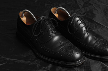 Leather black oxfords and brush. Studio photography