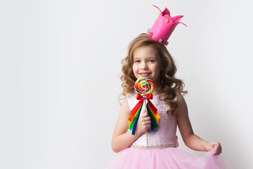 Girl in crown holding lollipop