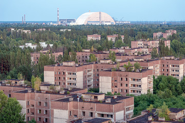 Fototapeta na wymiar view of the new safe confinement arch at the Chernobyl nuclear power plant through the prospect of abandoned Pripyat. NSF is a new sarcophagus for safe deactivation work