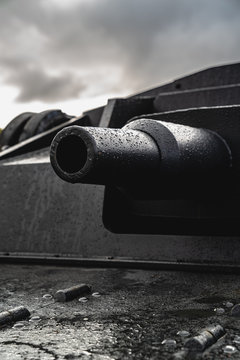 Tank barrel closeup. Cloudy sky on the background. Vertical photo