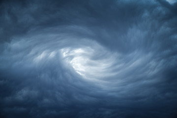 The eye of a tornado starts to create a vortex from grey couds