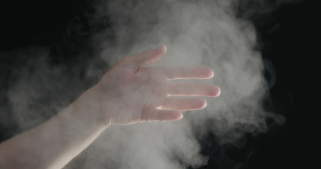 Fototapeta na wymiar man hand playing with water mist
