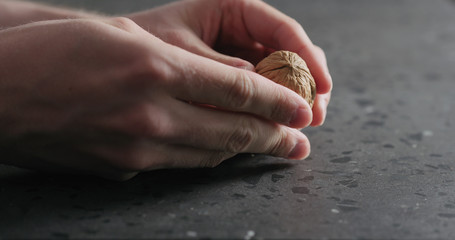 closeup man hands opens walnut