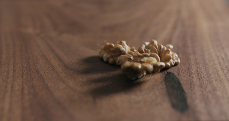 Fototapeta na wymiar peeled walnut on walnut wood surface