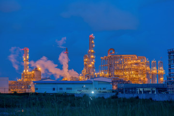 Fototapeta na wymiar Industrial oil refinery plant form industry zone with twilight at night,oil storage tank , factory equipment industry