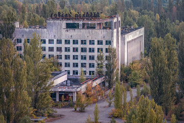 Fototapeta na wymiar aerial view of the central square of Pripyat and the Polissya Hotel. a lot of empty concrete floors overgrown with trees. Pripyat is empty after the evacuation for 33 years after the accident 