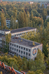 Fototapeta na wymiar aerial view of the lost city of Pripyat. a lot of empty concrete floors overgrown with trees. Pripyat is empty after the evacuation for 33 years after the accident at the Chernobyl nuclear power plant