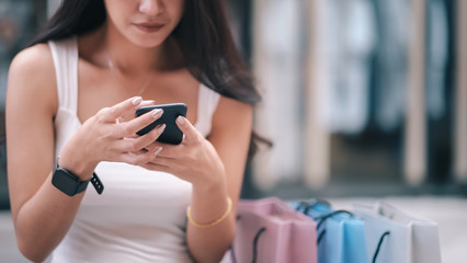 Fototapeta premium Closeup woman hand using mobilephone in shopping.