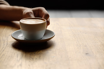 a cup of coffee in the hands. soft light