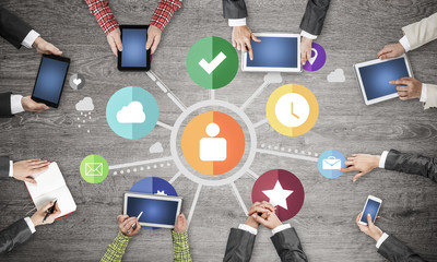 Top view of businesspeople sitting at table and using gadgets