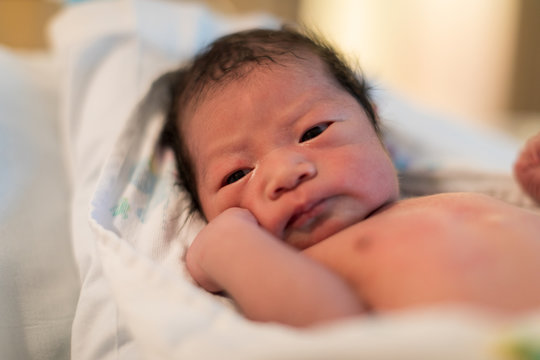 Just Born Asian Baby Laying In The Infant Bassinet Basket