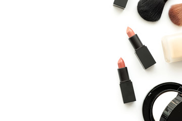 Obraz premium Flat lay image of beauty cosmetics make up with lipsticks, foundation and brushes. Top view with copy space, for your text.