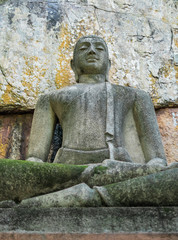 Buddha statue sitting in the lotus position, made of concrete.