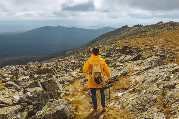 Young active motivated backpackers on top of a mountain enjoying valley view, full length back view photo, amazing landscape in the background of the photo. freedom © alfa27