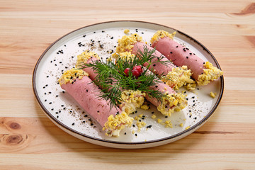 Ham rolls stuffed with egg, soft cheese and garlic