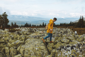 Fototapeta premium ambitious active guy with a travel backpack walking on the top mountain, extreme sport, full length side view photo. copy space