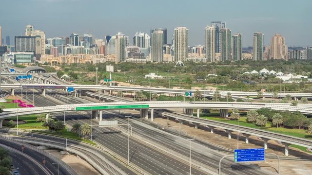 Dubai Golf Course with a cityscape of Gereens and tecom districts at the background aerial timelapse. Traffic on sheikh zayed road with junction